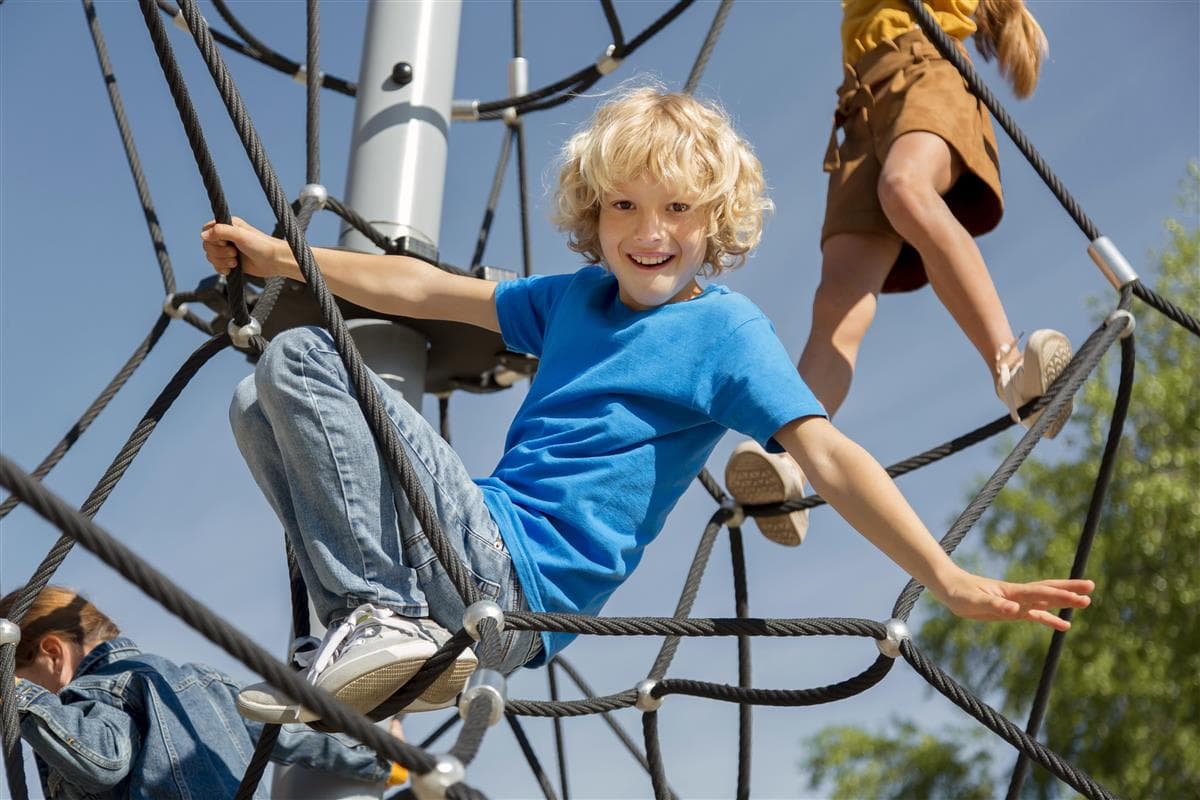 children-climbing-rope-together-close-up